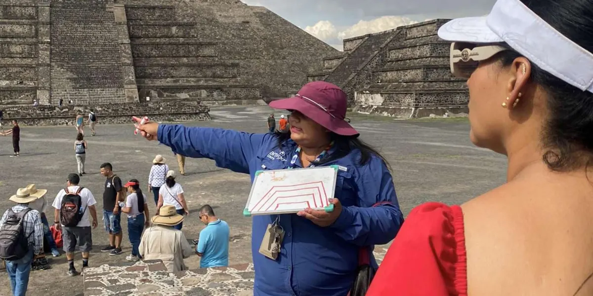 Guide pointing out features of a Teotihuacan pyramid