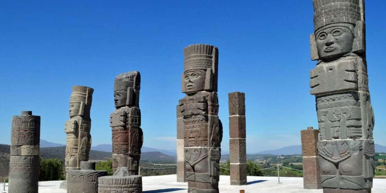 Toltec Atlantean warrior figures beneath a blue sky