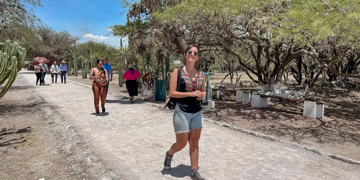 Visitor walking along a shaded archaeological-site path
