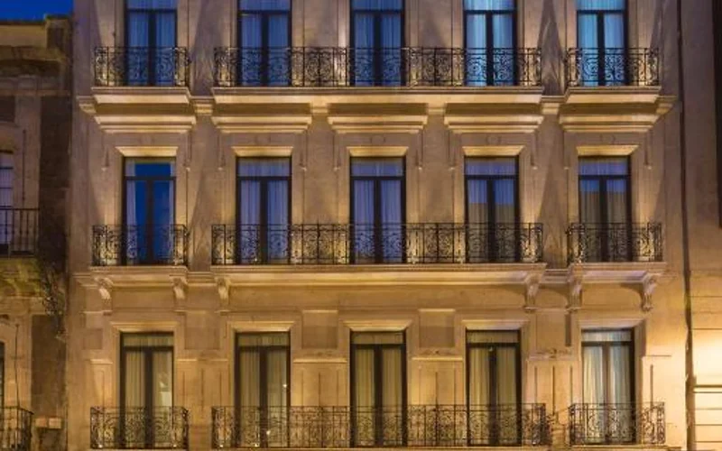 Illuminated facade and balconies of Historico Central Hotel