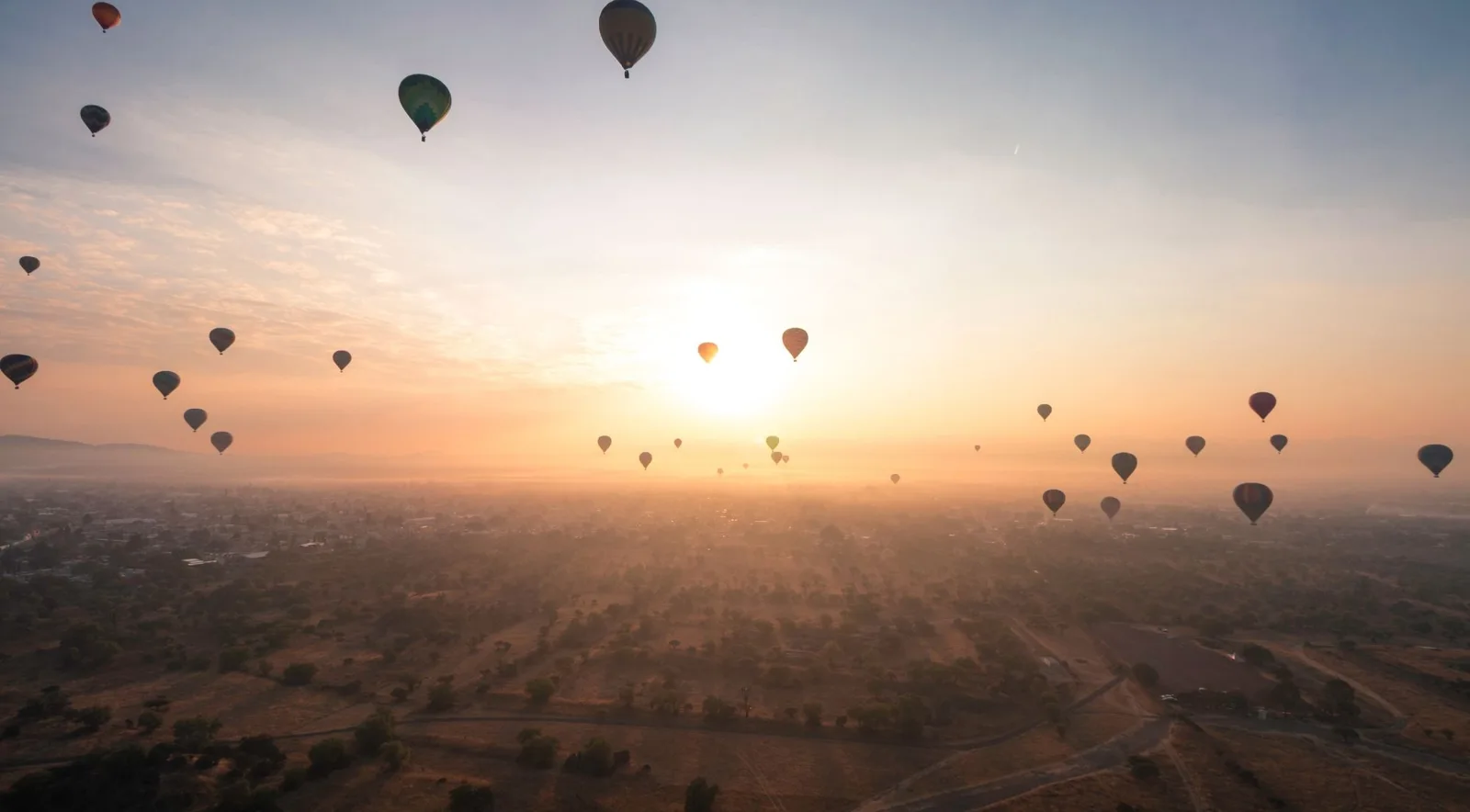 Sunrise light across the balloon-filled valley